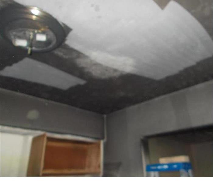 Repaired ceiling after a fire where the soot has been cleaned and the ceiling has been restored.