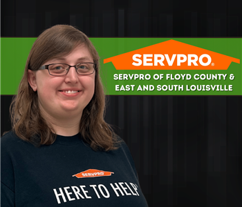 woman smiling at camera on a black background with a SERVPRO logo