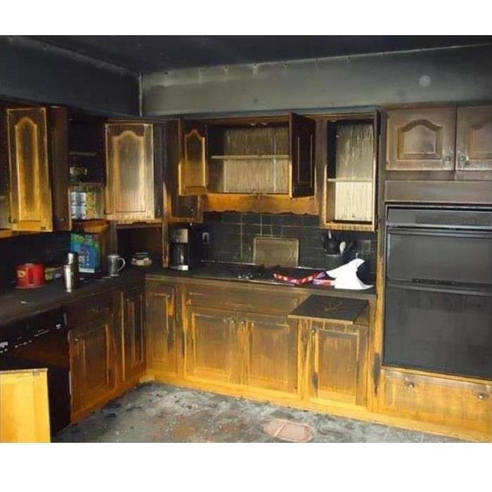All the cabinets have been blackened by smoke from a kitchen fire